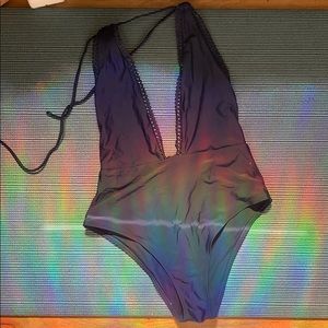 One piece blue bathing suit. Low cut